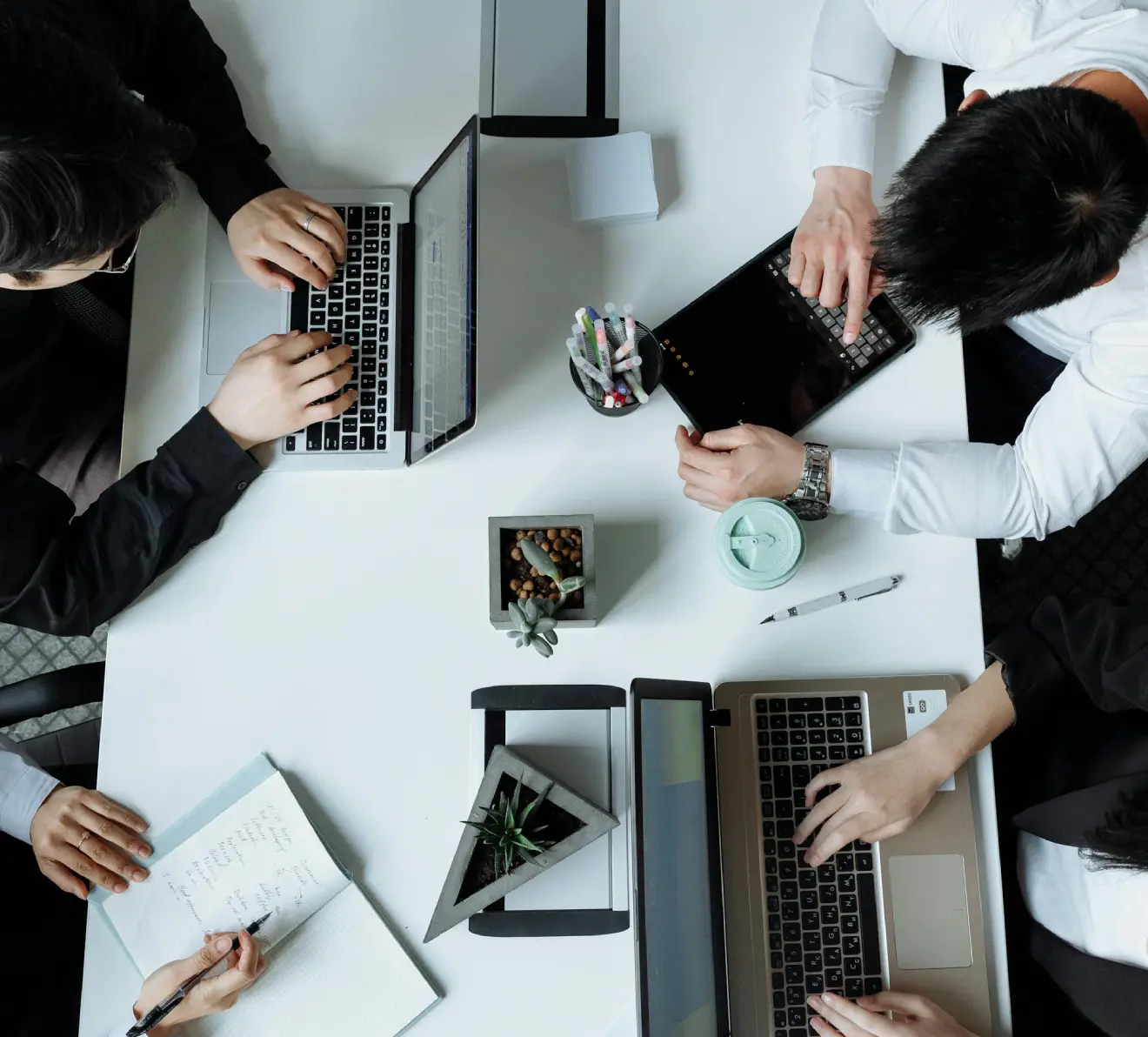 Team working on laptops and documents in a business outsourcing operations overview setting