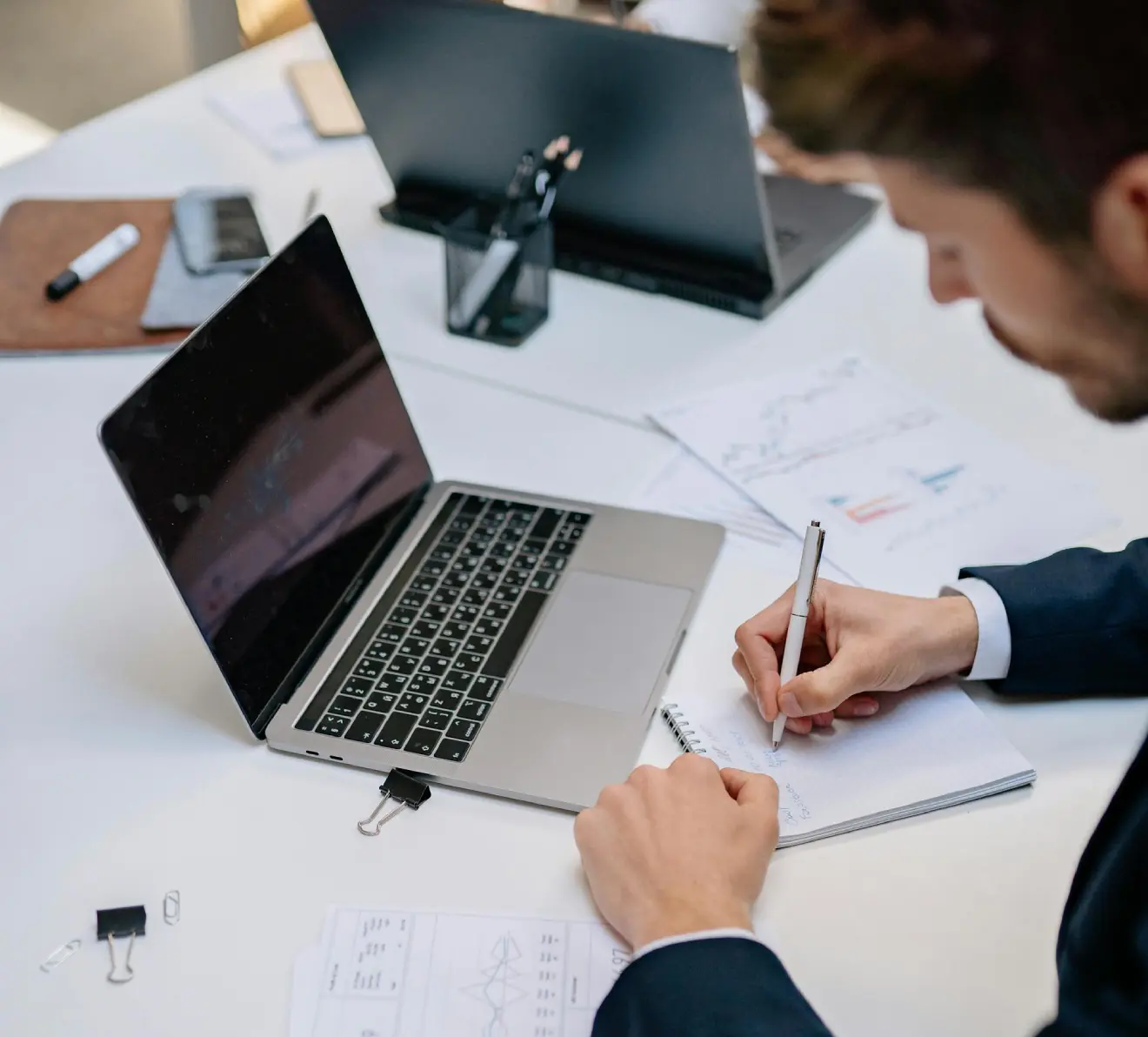 Professional working on financial reports and data entry on laptop for accounting services