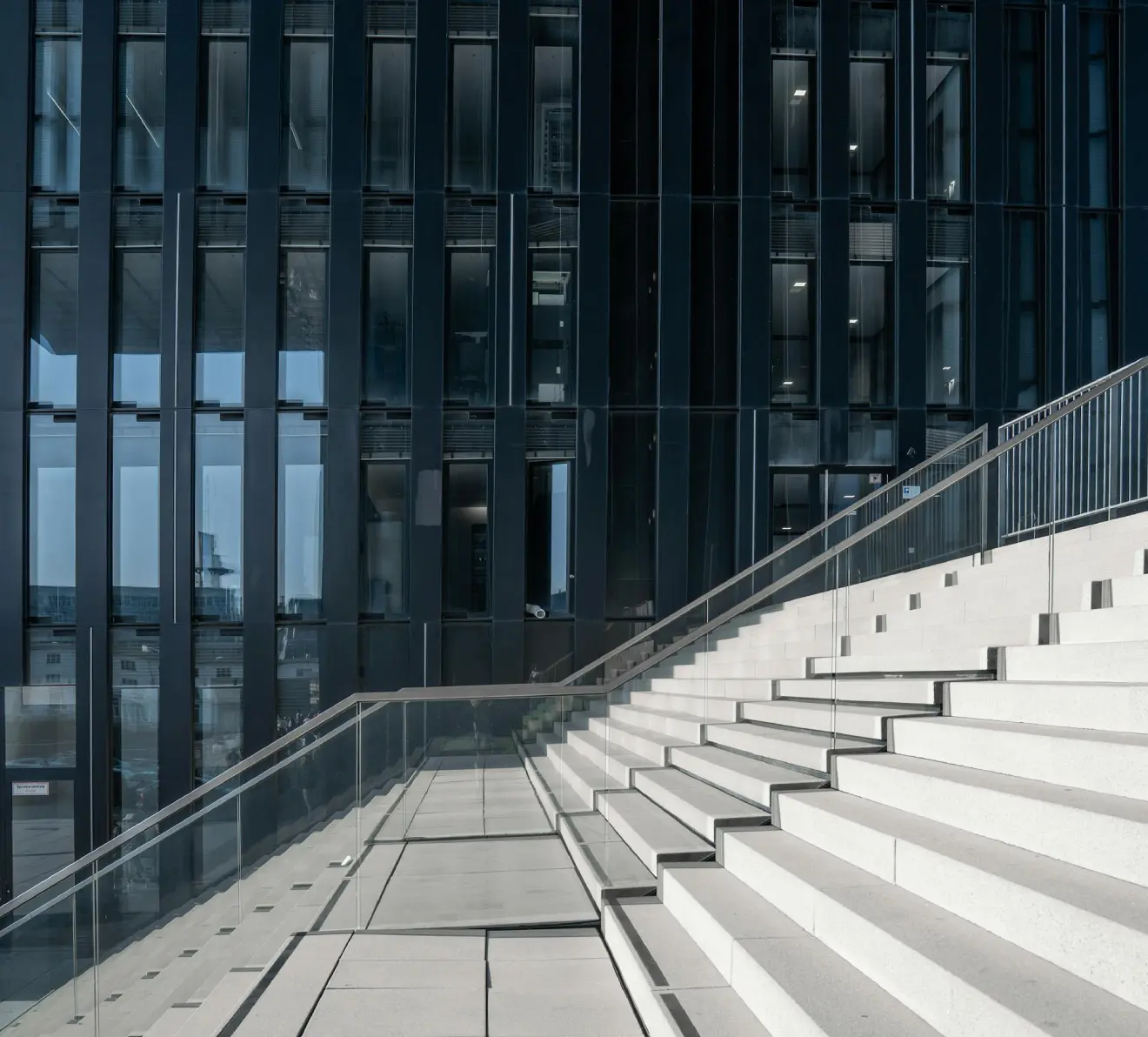 Modern architectural stairs and glass facade symbolizing structured growth in corporate finance