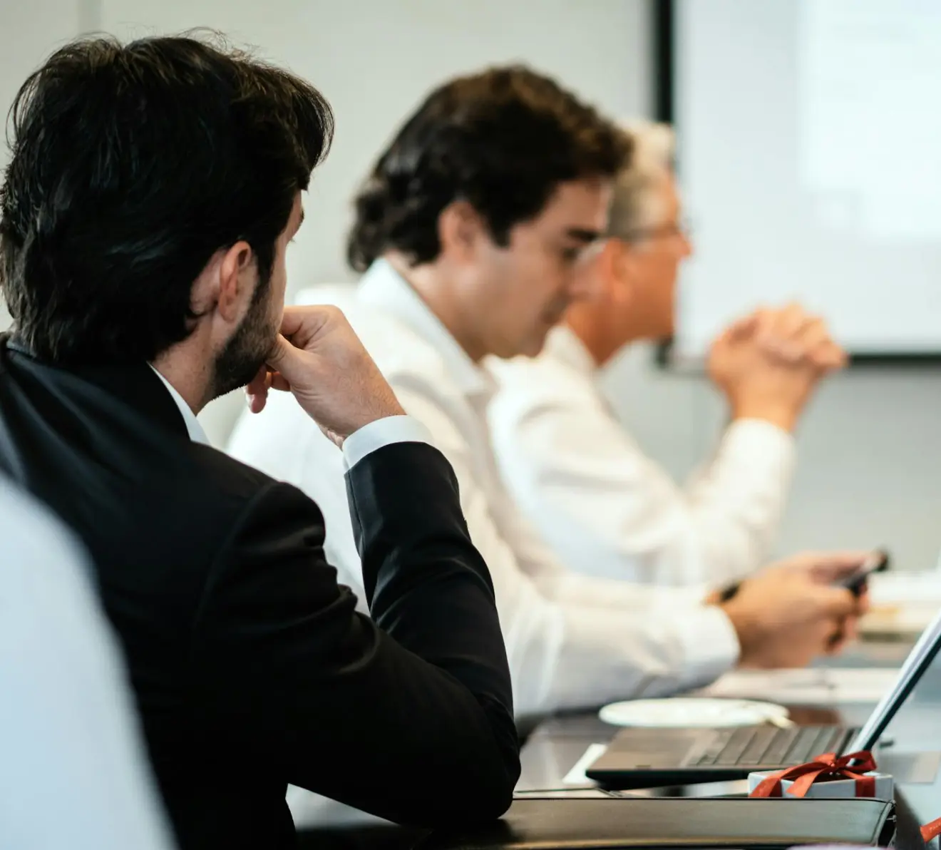 Executives in corporate governance meeting reviewing strategy and compliance matters
