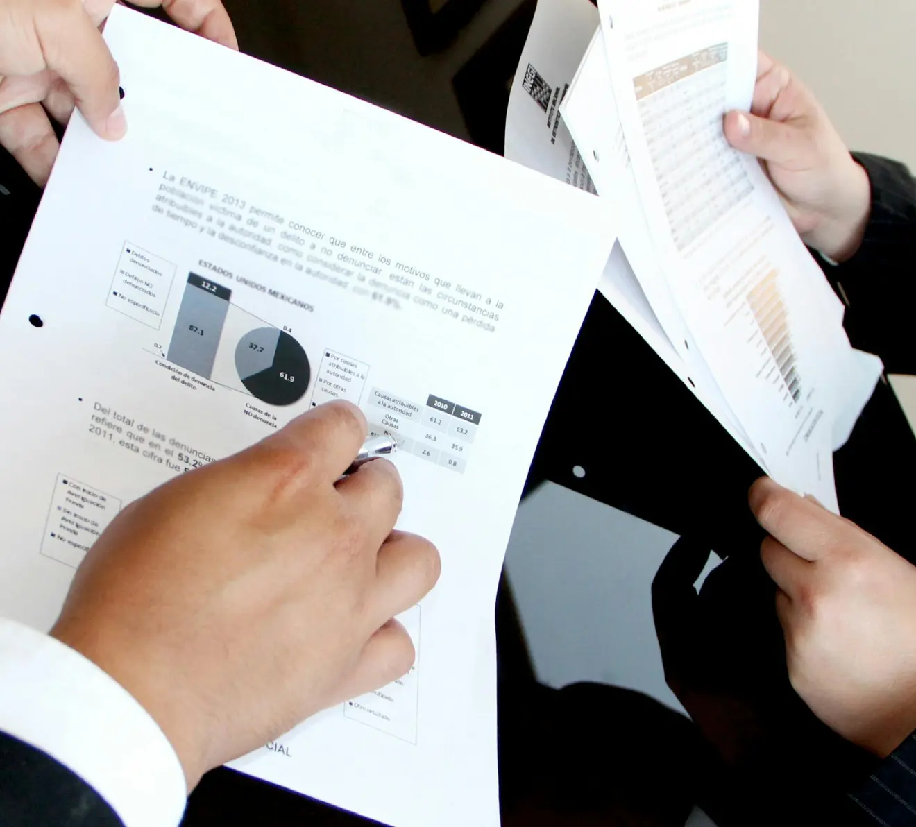 Professionals reviewing financial reports and data during internal audit and governance process