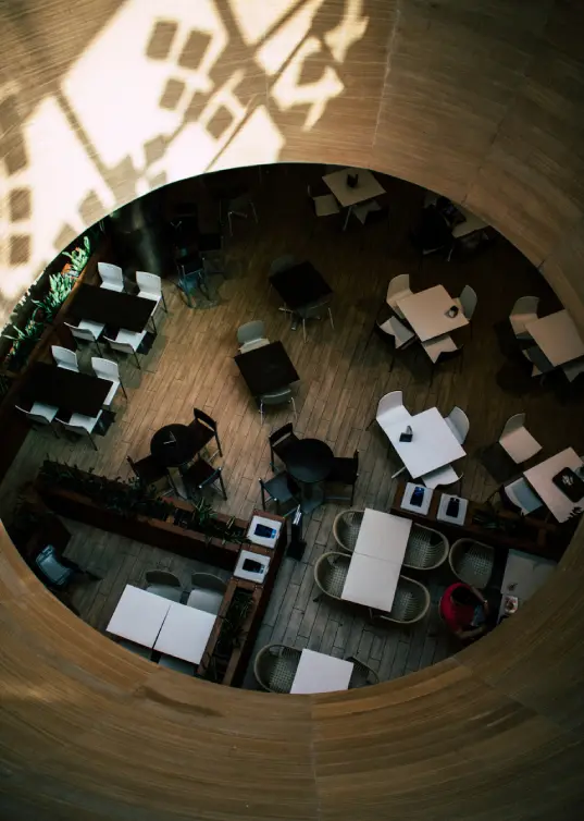 Top view of a modern office interior with desks and chairs in an architectural circular layout