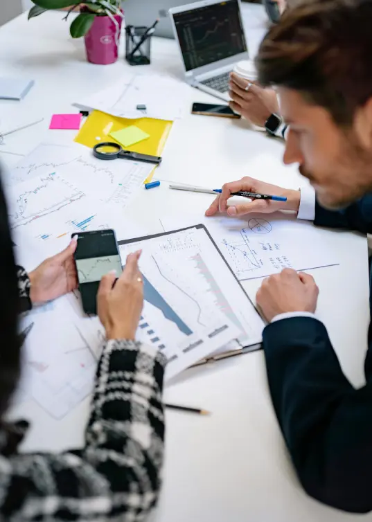 Business team analyzing financial data and charts during outsourcing operations planning