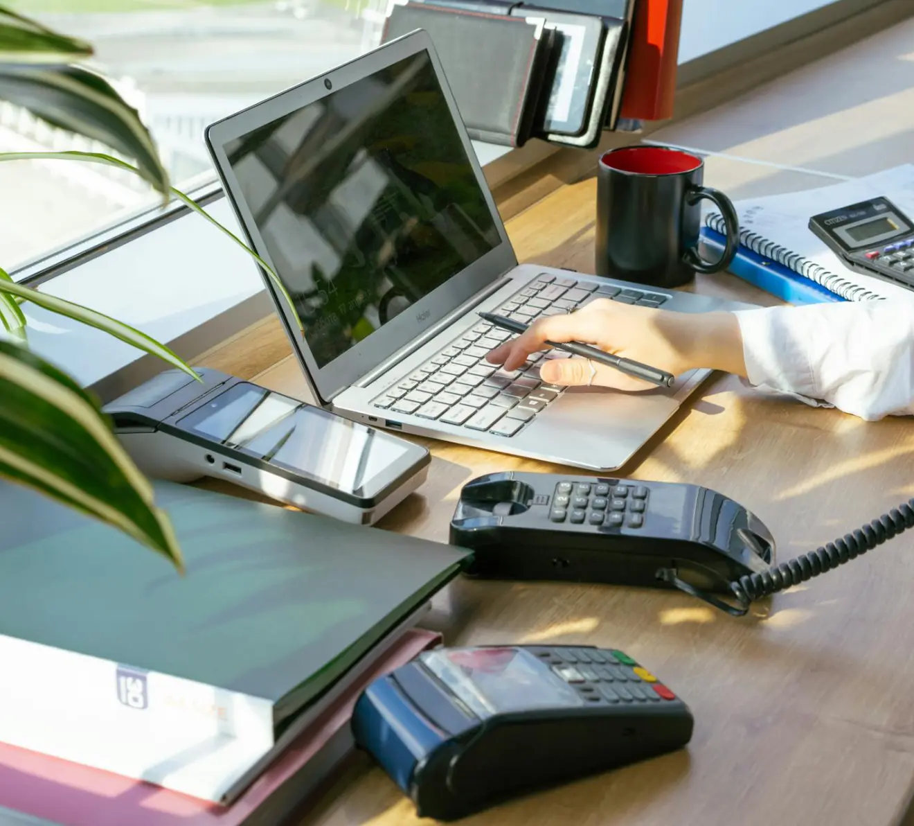 Payroll processing and salary calculation on laptop with accounting tools on desk