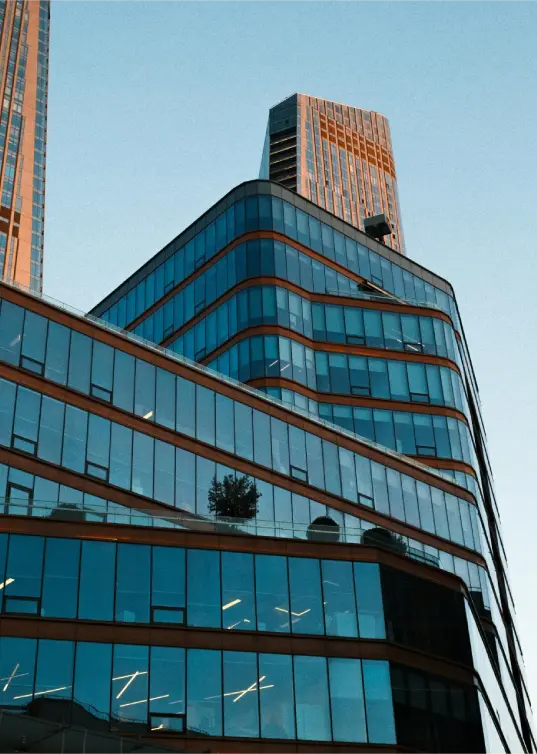 Modern architectural building with layered glass structure representing tax advisory overview and strategic perspective