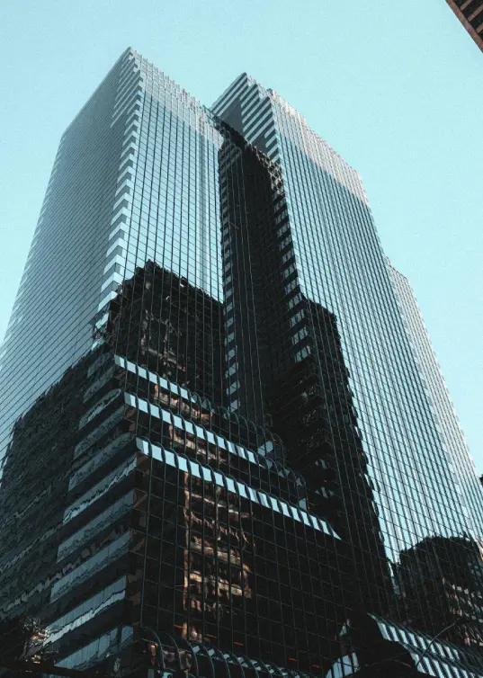 Modern glass tower with symmetrical structure representing tax compliance and regulatory control